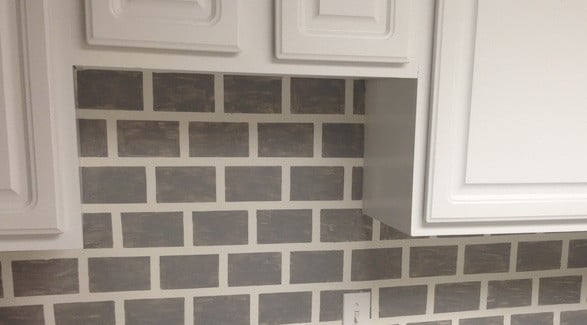 kitchen wall painted to look like tile