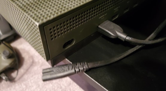 Unplug the Xbox power cord from the back of the console itself