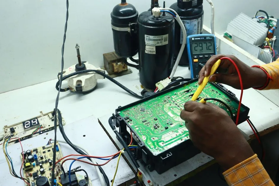 The 50% Rule for Appliance Repair: When to Repair vs Replace 1 Technician diagnosing an AC control board with tools spread across a workshop bench