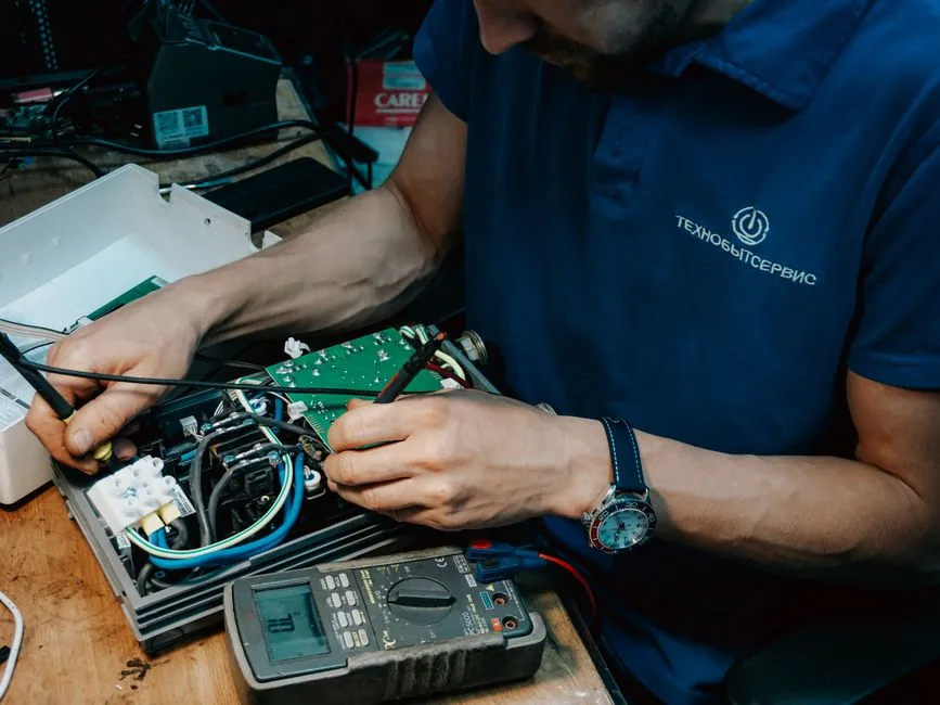 Why Would a Microwave Suddenly Stop Working? 2 A technician methodically repairs a circuit board, showcasing expertise in electronics and technical skills.