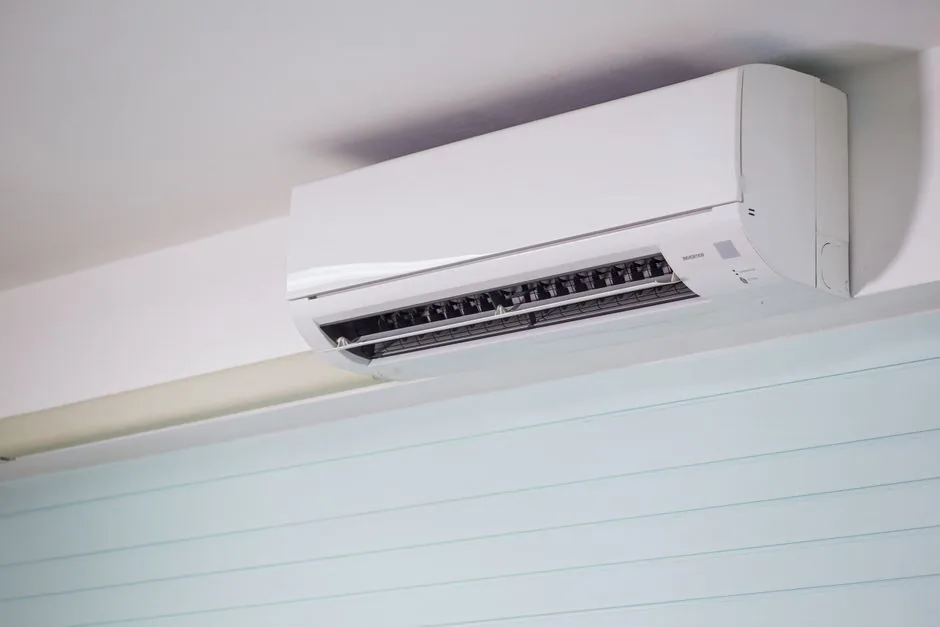 Ductless Mini-Split vs Central AC: Cost and Efficiency Compared 3 Close-up of a wall-mounted air conditioner indoors, showcasing sleek design for modern cooling solutions.
